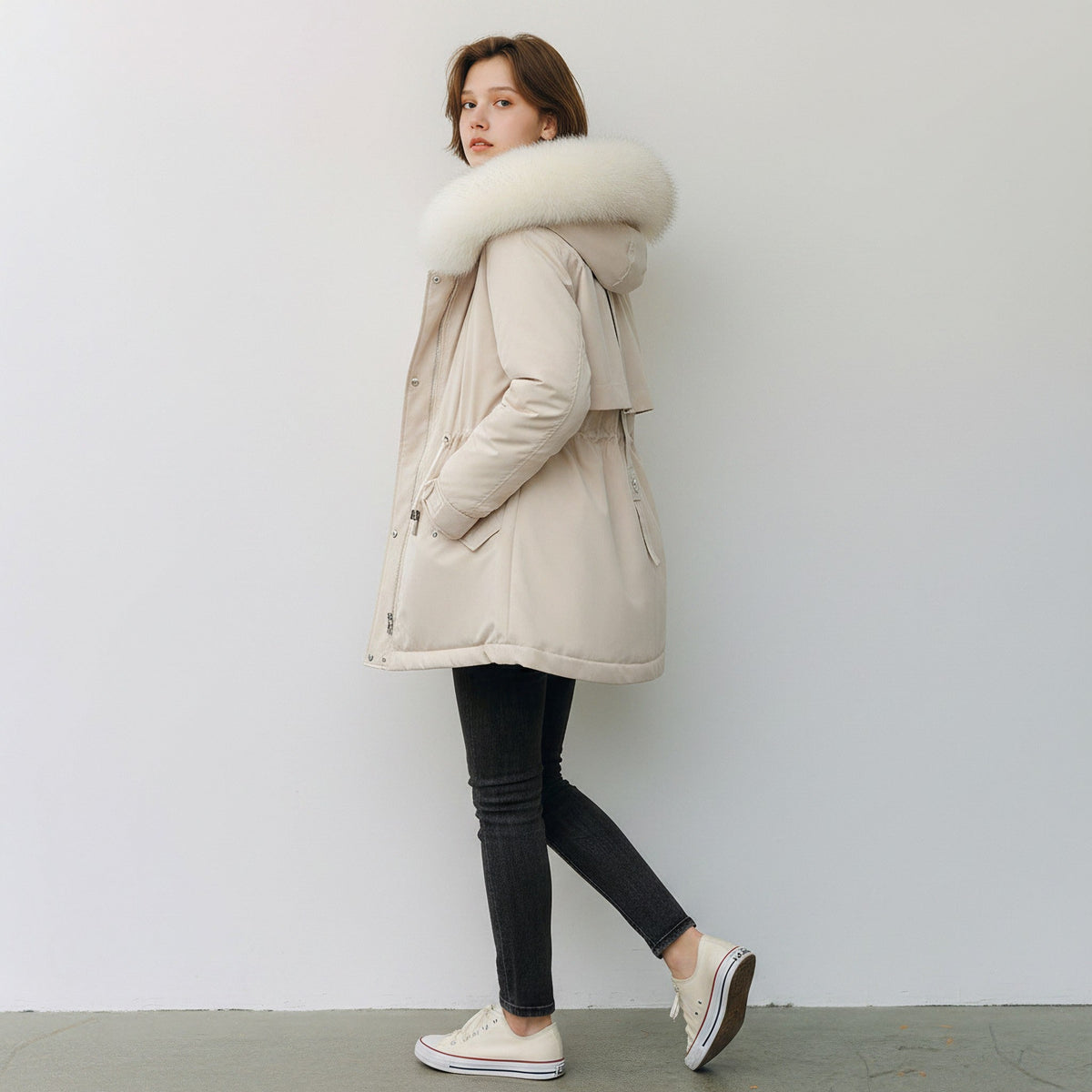 pikywiky beige puffer jacket with a plush faux fur hood, worn by a woman in black jeans and white sneakers