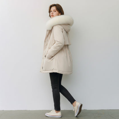pikywiky beige puffer jacket with a plush faux fur hood, worn by a woman in black jeans and white sneakers