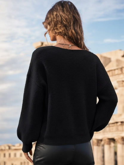 pikywiky black long sleeve ribbed knit sweater with a V-neckline worn by a woman outdoors