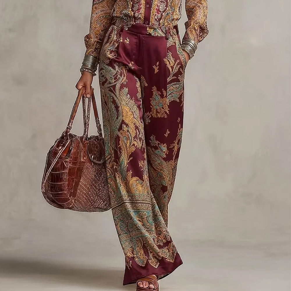 pikywiky burgundy paisley print wide leg trousers and matching button up shirt set with a brown leather handbag