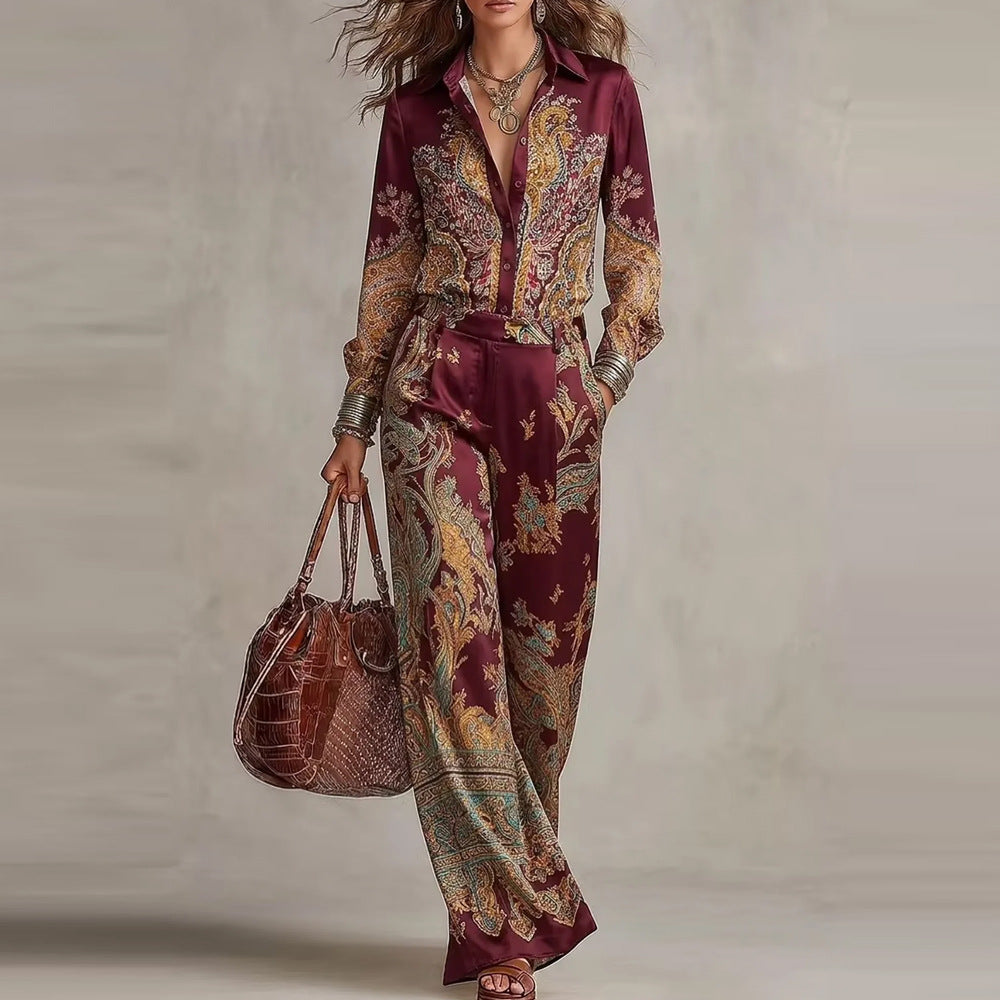 pikywiky burgundy paisley print silky long sleeve button up shirt and wide leg trouser set worn by a woman