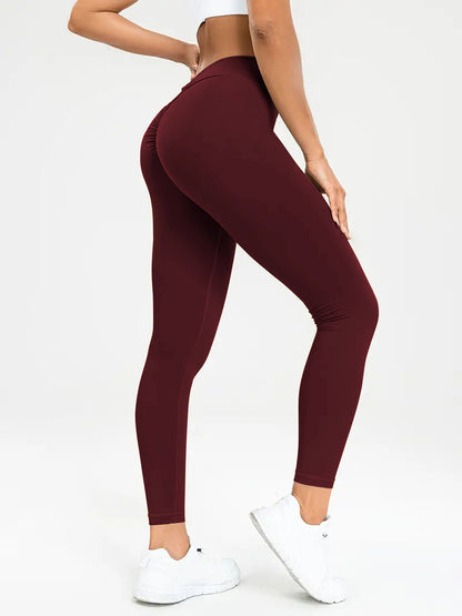 pikywiky high-waisted burgundy athletic leggings with ruched back detail for a sculpted fit on a model