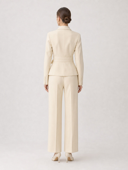 Back view of pikywiky cream tailored blazer and wide-leg trouser suit set with a belted waist on a model.