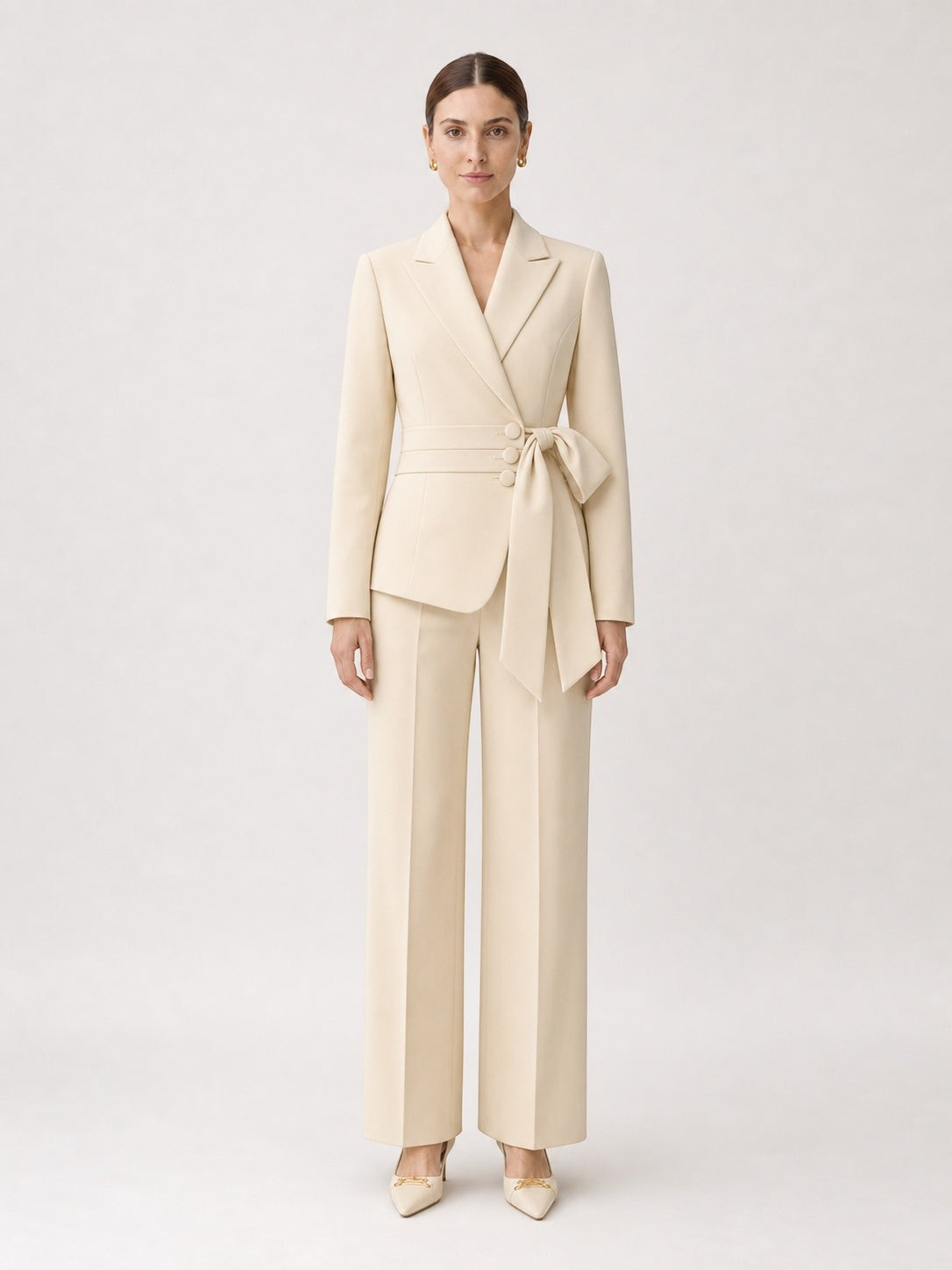 Model wearing a pikywiky cream tailored blazer with a side-tie waist belt and matching wide-leg trousers.