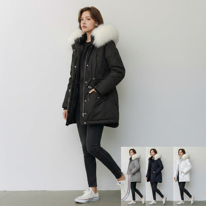 pikywiky black puffer jacket with white faux fur hood worn by a model with jeans and sneakers