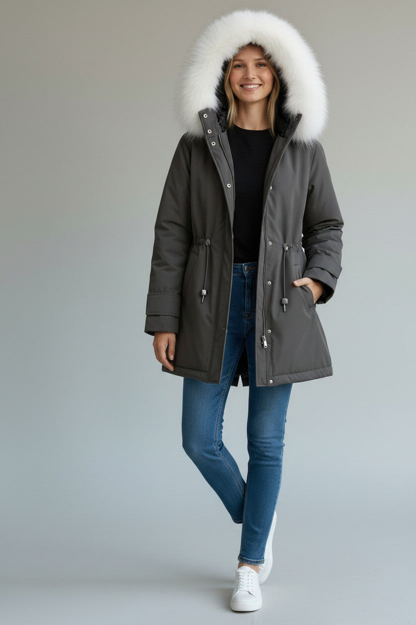 pikywiky grey puffer jacket with plush white faux fur hood worn by a smiling woman with blue jeans