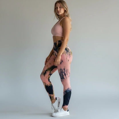 A model wearing pikywiky high-waisted athletic leggings with a pink and black abstract ink print and a pink sports bra.