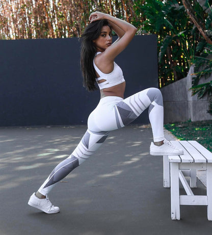 pikywiky high waisted athletic leggings with white and grey geometric patterns worn by a woman stretching outdoors