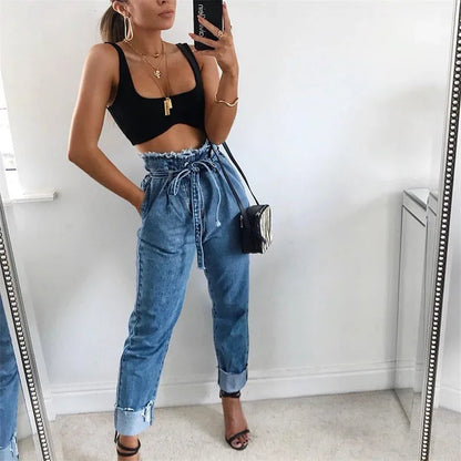 pikywiky high-waisted blue denim jeans with a paperbag waist, tie-belt, and raw frayed hem worn by a woman