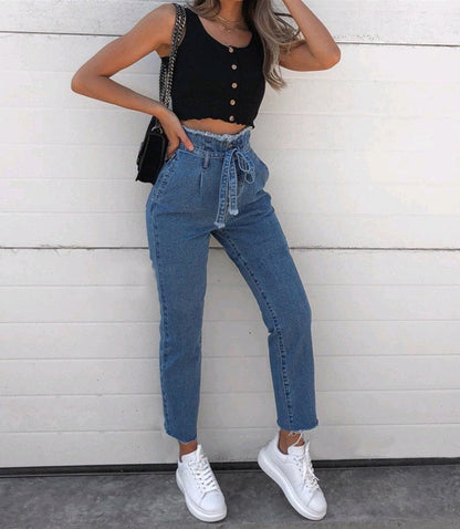 pikywiky high-waisted blue denim jeans with a paperbag waist, tie-belt, and raw frayed hem worn by a model