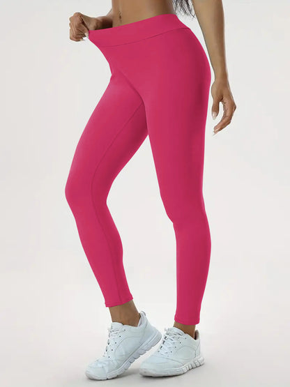 pikywiky high-waisted hot pink athletic leggings with ruched back detail worn by a model with white sneakers