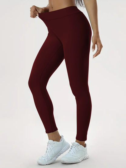 pikywiky high-waisted maroon athletic leggings with ruched back detail worn by a model for yoga and fitness training