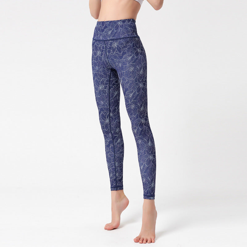 pikywiky high-waisted yoga leggings in navy blue with a white floral line art print and moisture-wicking fabric.