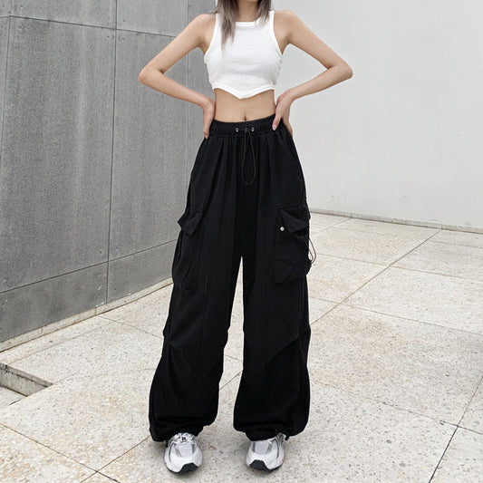 Pikywiky women's relaxed black cargo pants with side pockets in an urban setting