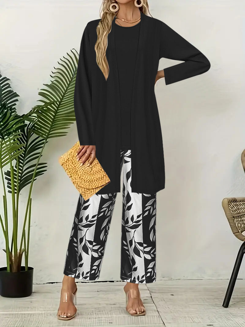 pikywiky three-piece outfit featuring a black sleeveless top, long cardigan, and wide-leg pants with a leaf print.