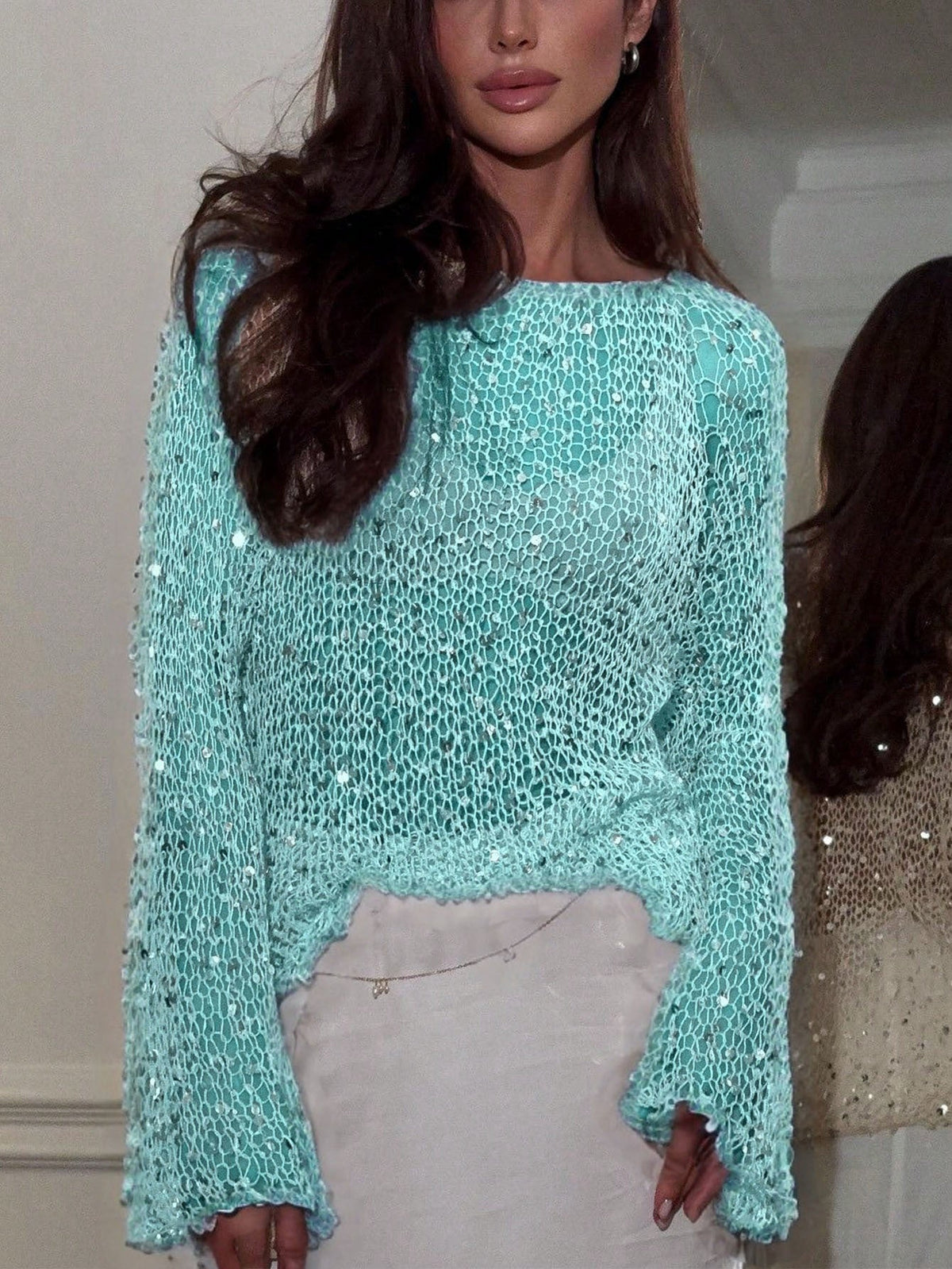 pikywiky turquoise open knit long sleeve sweater with shimmering sequins worn by a woman with long brown hair