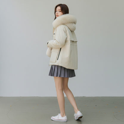 pikywiky white puffer jacket with a plush faux fur hood, worn by a woman with a grey pleated skirt and white sneakers