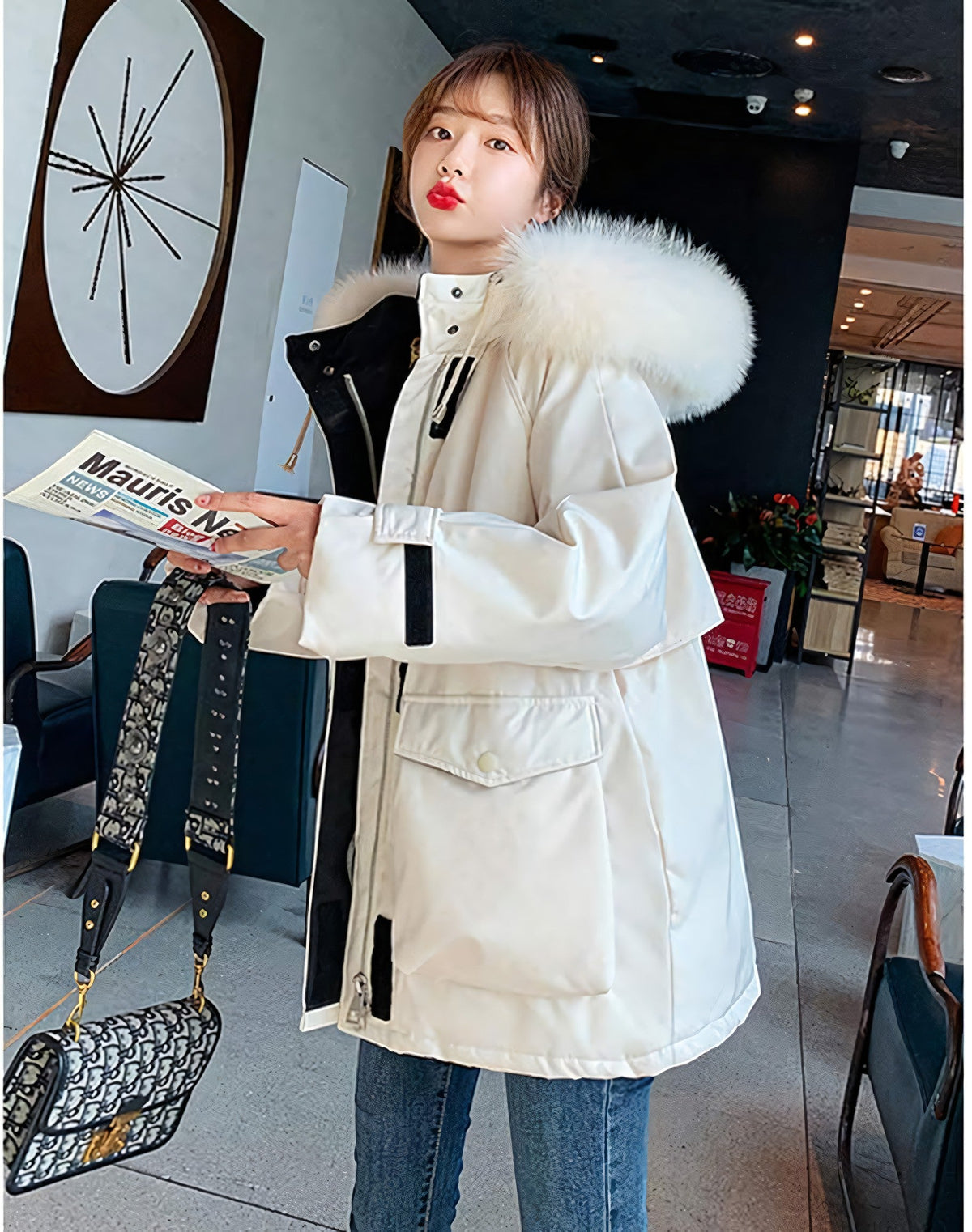 pikywiky white puffer jacket with plush faux fur hood and oversized pockets worn by a woman holding a newspaper