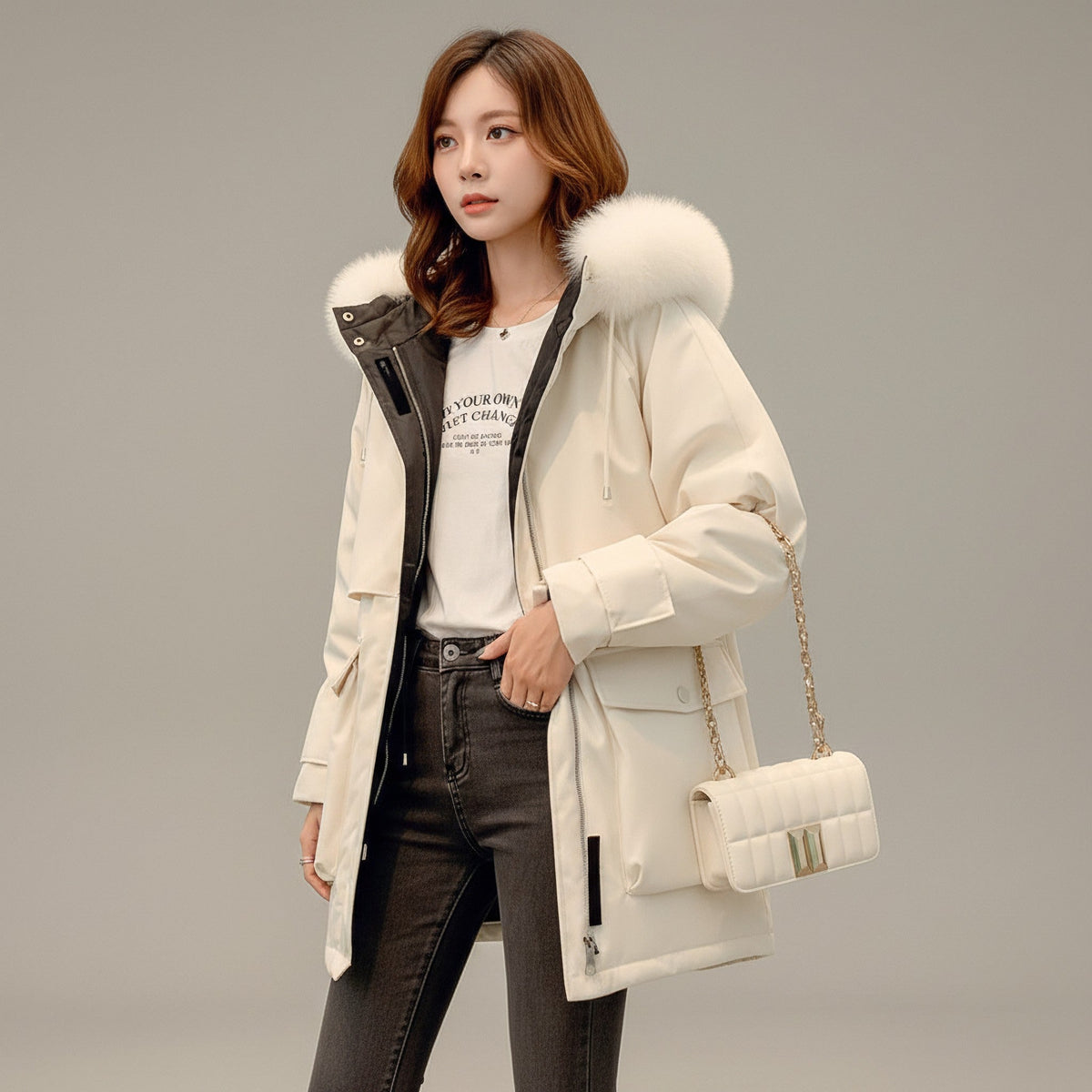 pikywiky white puffer jacket with plush faux fur hood trim worn by a woman with a white quilted shoulder bag