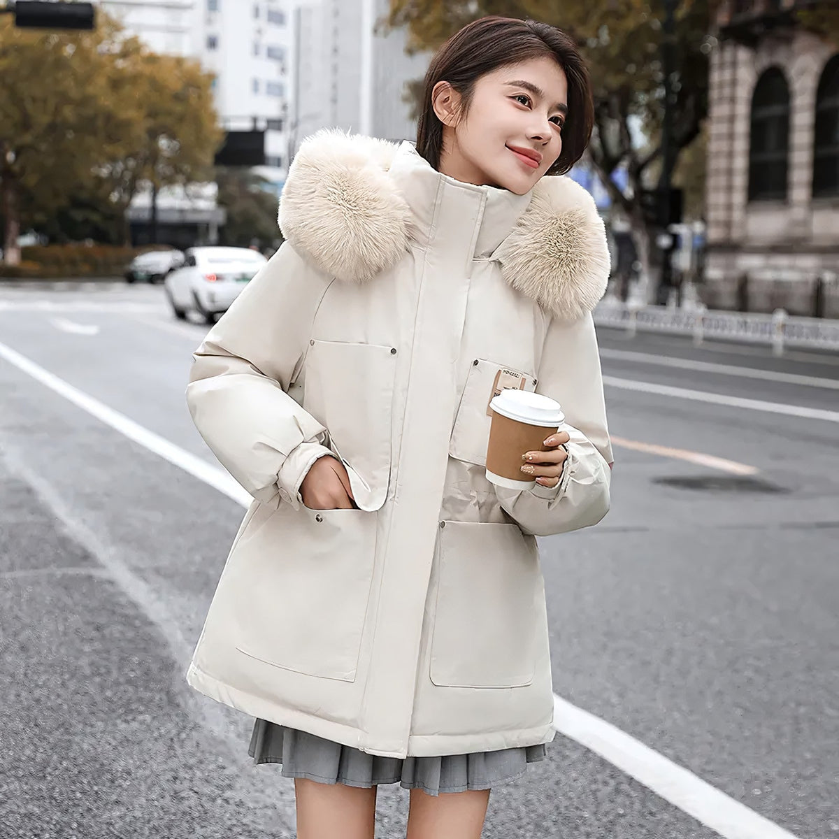 pikywiky white puffer jacket with plush faux fur hood and oversized pockets worn by a woman on a city street